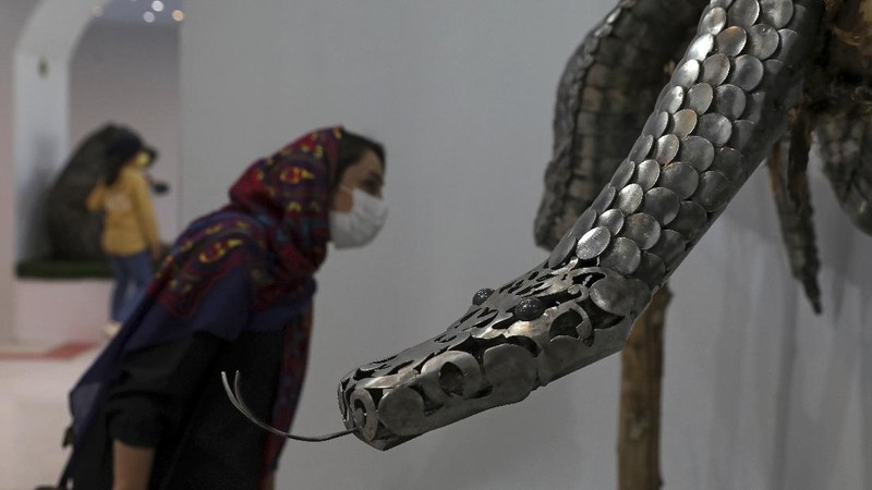 Children visit indoor area of Shahreza Metal Zoo in the central city of Shahreza some 265 miles (425 kilometer) south of the capital Tehran, Iran, Wednesday, Oct. 13, 2021. The zoo hosts 30 life-sized animal sculptures of two Iranian artist brothers. Ehsan and Soheil Saanei have made the sculptures with thousands of salvaged bearings, gears, cogwheels, chains, nuts, and bolts meshed with each other to create elaborate animals that capture the form of its real-life creature in metal. A message to both show their opposition to traditional zoos and at the same time help the city with recycling of the discarded metal parts through their project. (AP Photo/Vahid Salemi)