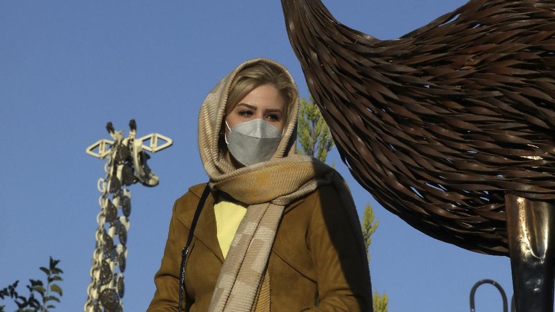 A woman visits Shahreza Metal Zoo in the central city of Shahreza some 265 miles (425 kilometer) south of the capital Tehran, Iran, Wednesday, Oct. 13, 2021. The zoo hosts 30 life-sized animal sculptures of two Iranian artist brothers. Ehsan and Soheil Saanei have made the sculptures with thousands of salvaged bearings, gears, cogwheels, chains, nuts, and bolts meshed with each other to create elaborate animals that capture the form of its real-life creature in metal. A message to both show their opposition to traditional zoos and at the same time help the city with recycling of the discarded metal parts through their project. (AP Photo/Vahid Salemi)