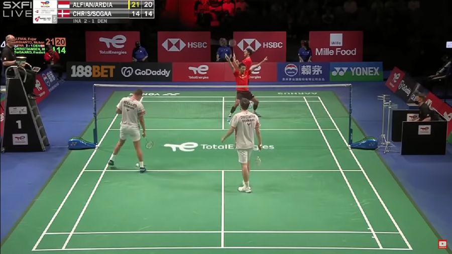 Indonesia's Anthony Sinisuka Ginting returns the shuttlecock to Denmark's Viktor Axelsen during a mens single match in the Thomas Cup mens team Badminton semifinal match between Denmark and Indonesia, in Aarhus, Denmark, Saturday Oct. 16, 2021. (Claus Fisker/Ritzau Scanpix via AP)