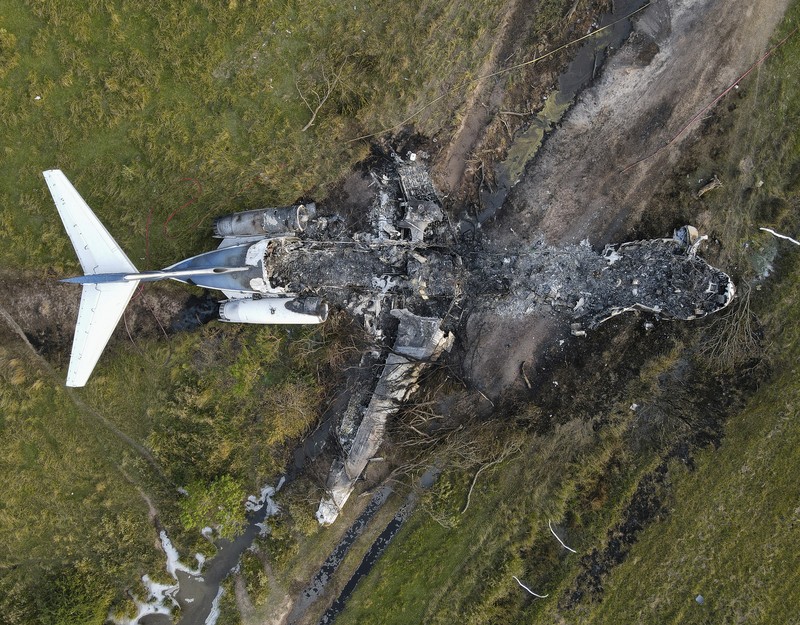 In this frame grab from video provided by KTRK, firefighters work the scene where a plane taking passengers from Texas to the AL Championship Series game in Boston burst into flames after it ran off a runway during takeoff Tuesday, Oct. 19, 2021, in Brookshire, Texas. No one was seriously hurt, authorities said. (KTRK via AP)