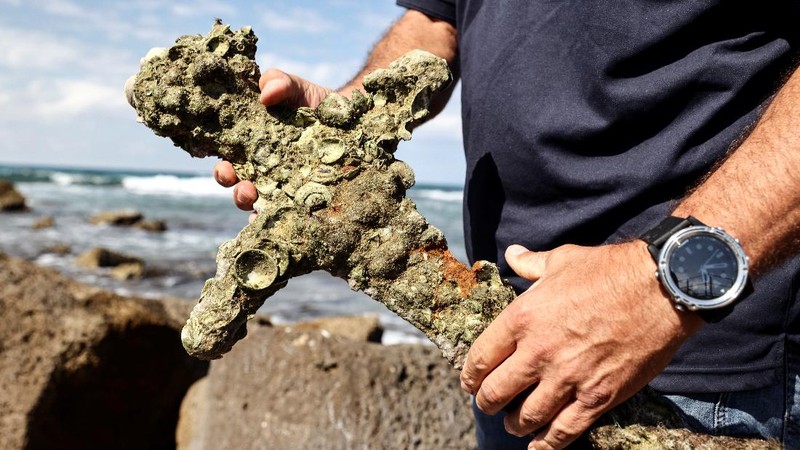 A sword believed to have belonged to a Crusader who sailed to the Holy Land almost a millennium ago lays on the beach near to where it was recovered from the Mediterranean seabed by an amateur diver, the Israel Antiquities Authority said, Caesarea, Israel October 18, 2021. REUTERS/Ronen Zvulun