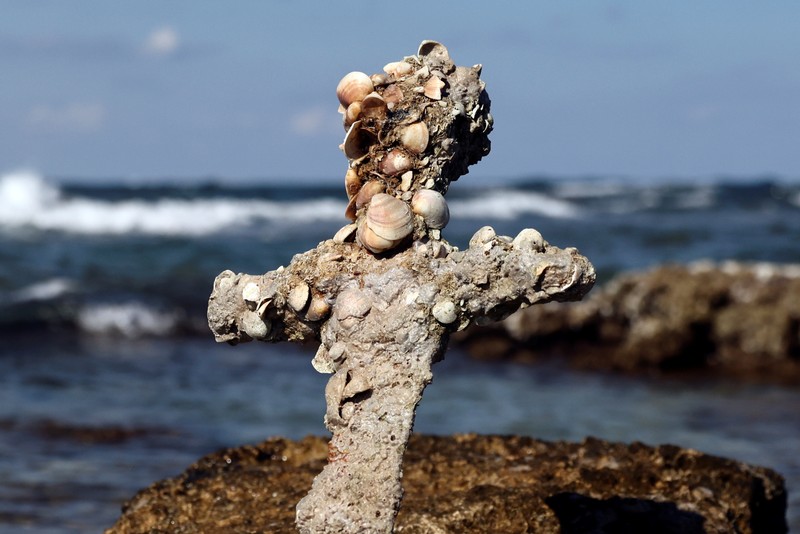 A sword believed to have belonged to a Crusader who sailed to the Holy Land almost a millennium ago lays on the beach near to where it was recovered from the Mediterranean seabed by an amateur diver, the Israel Antiquities Authority said, Caesarea, Israel October 18, 2021. REUTERS/Ronen Zvulun