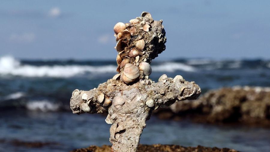 A sword believed to have belonged to a Crusader who sailed to the Holy Land almost a millennium ago lays on the beach near to where it was recovered from the Mediterranean seabed by an amateur diver, the Israel Antiquities Authority said, Caesarea, Israel October 18, 2021. REUTERS/Ronen Zvulun