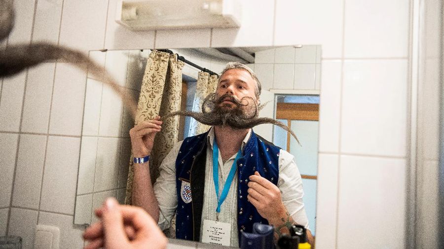 Participant Norbert Dopf from Austria arrives for the German Moustache and Beard Championships 2021 at Pullman City Western Theme Park in Eging am See, Germany, October 23, 2021. REUTERS/Lukas Barth     TPX IMAGES OF THE DAY