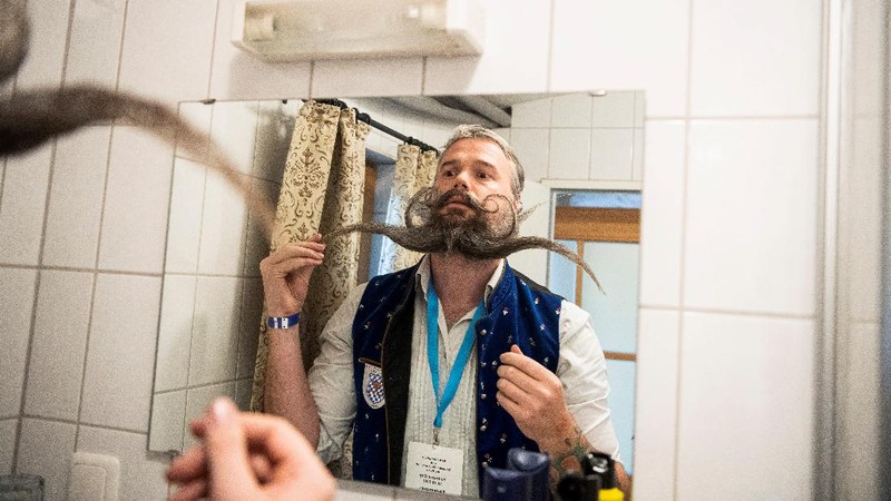 Participant Norbert Dopf from Austria arrives for the German Moustache and Beard Championships 2021 at Pullman City Western Theme Park in Eging am See, Germany, October 23, 2021. REUTERS/Lukas Barth     TPX IMAGES OF THE DAY