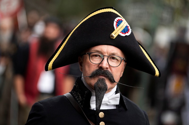 Peserta kejuaraan kumis dan jenggot Jerman 2021 Participant Norbert Dopf from Austria arrives for the German Moustache and Beard Championships 2021 at Pullman City Western Theme Park in Eging am See, Germany, October 23, 2021. REUTERS/Lukas Barth TPX IMAGES OF THE DAY
