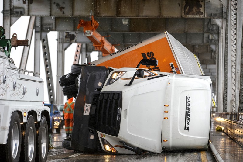 Vehicles make their way through a flooded area of High Street near Interstate 880 as rain falls in Oakland, Calif., on Sunday, Oct. 24, 2021. (Jane Tyska/Bay Area News Group via AP)