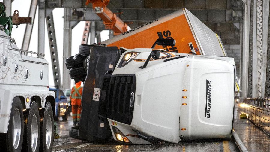 Vehicles make their way through a flooded area of High Street near Interstate 880 as rain falls in Oakland, Calif., on Sunday, Oct. 24, 2021. (Jane Tyska/Bay Area News Group via AP)