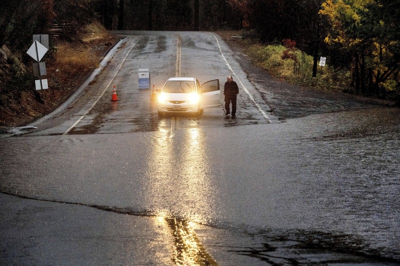 Vehicles make their way through a flooded area of High Street near Interstate 880 as rain falls in Oakland, Calif., on Sunday, Oct. 24, 2021. (Jane Tyska/Bay Area News Group via AP)