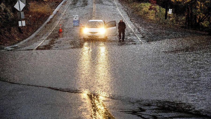 Vehicles make their way through a flooded area of High Street near Interstate 880 as rain falls in Oakland, Calif., on Sunday, Oct. 24, 2021. (Jane Tyska/Bay Area News Group via AP)