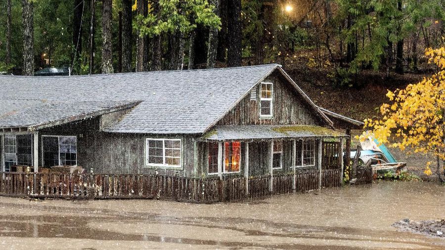 Vehicles make their way through a flooded area of High Street near Interstate 880 as rain falls in Oakland, Calif., on Sunday, Oct. 24, 2021. (Jane Tyska/Bay Area News Group via AP)