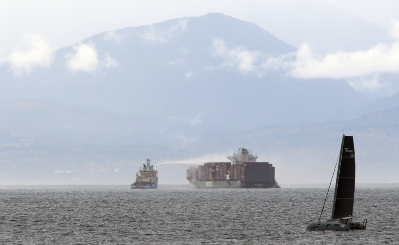Canada Container Ship Fire Ships work to control a fire onboard the MV Zim Kingston about 8 kilometers (5 miles) from the shore in Victoria, British Columbia, Canaeda, on Sunday, Oct. 24, 2021. The container ship caught fire on Saturday and 16 crew members were evacuated and brought to Ogden Point Pier. (Chad Hipolito/The Canadian Press via AP)