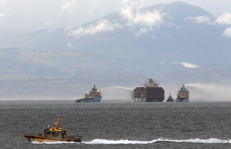Canada Container Ship Fire Ships work to control a fire onboard the MV Zim Kingston about 8 kilometers (5 miles) from the shore in Victoria, British Columbia, Canaeda, on Sunday, Oct. 24, 2021. The container ship caught fire on Saturday and 16 crew members were evacuated and brought to Ogden Point Pier. (Chad Hipolito/The Canadian Press via AP)