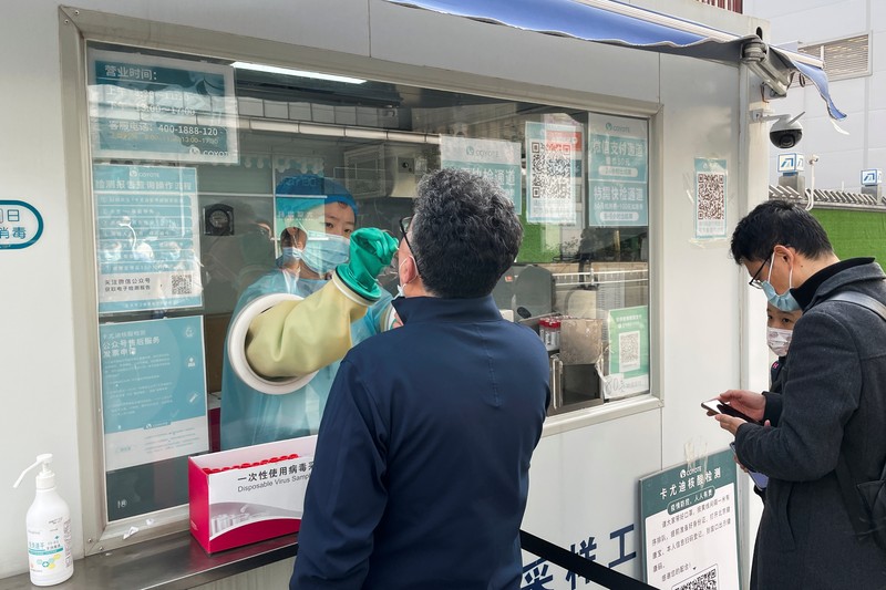This photo released by Xinhua News Agency shows an aerial view of residents lining up to receive a swab for the coronavirus test during a mass testing in Lanzhou, capital city of northwest China's Gansu Province, Sunday, Oct. 24, 2021. China's Gansu has closed all tourist sites following the reporting of new COVID-19 cases in the northwestern province. Gansu lies along the ancient Silk Road and is famed for the Dunhuang grottoes filled with Buddhist images and other ancient religious sites. (Fan Peishen/Xinhua via AP)