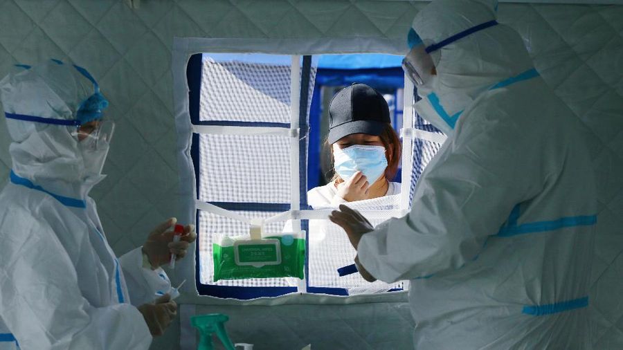 A medical worker in protective suit checks the information of a resident during a mass nucleic acid testing following a new case of the coronavirus disease (COVID-19) in Haidong's Pingan district, Qinghai province, China October 23, 2021. Picture taken October 23, 2021. cnsphoto via REUTERS ATTENTION EDITORS - THIS IMAGE WAS PROVIDED BY A THIRD PARTY. CHINA OUT.
