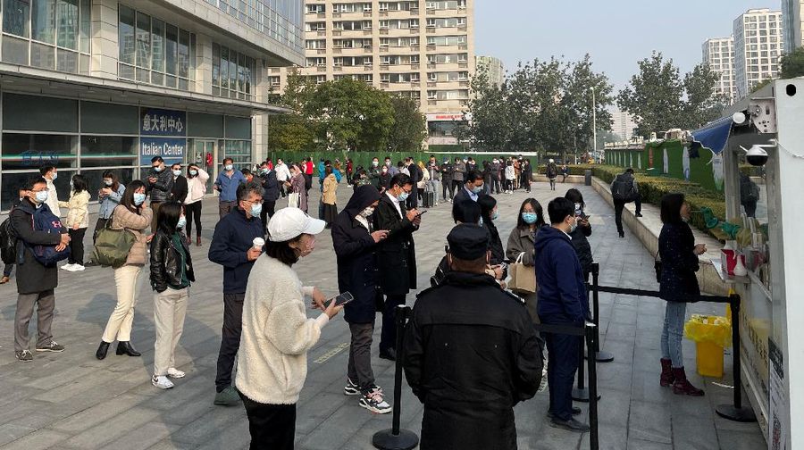 This photo released by Xinhua News Agency shows an aerial view of residents lining up to receive a swab for the coronavirus test during a mass testing in Lanzhou, capital city of northwest China's Gansu Province, Sunday, Oct. 24, 2021. China's Gansu has closed all tourist sites following the reporting of new COVID-19 cases in the northwestern province. Gansu lies along the ancient Silk Road and is famed for the Dunhuang grottoes filled with Buddhist images and other ancient religious sites. (Fan Peishen/Xinhua via AP)