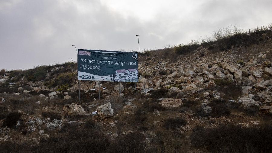 A billboard advertising new houses projects hangs on a hill in the West Bank Jewish settlement of Ariel near the Palestinian town of Nablus, Monday, Oct. 25, 2021. Israel is expected to move forward with thousands of new homes for Jewish settlers in the West Bank this week, a settlement watchdog group said Sunday. (AP Photo/Ariel Schalit)