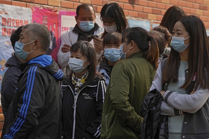 A medical worker in protective suit checks the information of a resident during a mass nucleic acid testing following a new case of the coronavirus disease (COVID-19) in Haidong's Pingan district, Qinghai province, China October 23, 2021. Picture taken October 23, 2021. cnsphoto via REUTERS   ATTENTION EDITORS - THIS IMAGE WAS PROVIDED BY A THIRD PARTY. CHINA OUT.