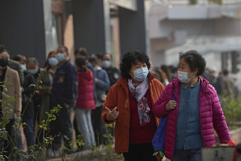 A medical worker in protective suit checks the information of a resident during a mass nucleic acid testing following a new case of the coronavirus disease (COVID-19) in Haidong's Pingan district, Qinghai province, China October 23, 2021. Picture taken October 23, 2021. cnsphoto via REUTERS   ATTENTION EDITORS - THIS IMAGE WAS PROVIDED BY A THIRD PARTY. CHINA OUT.