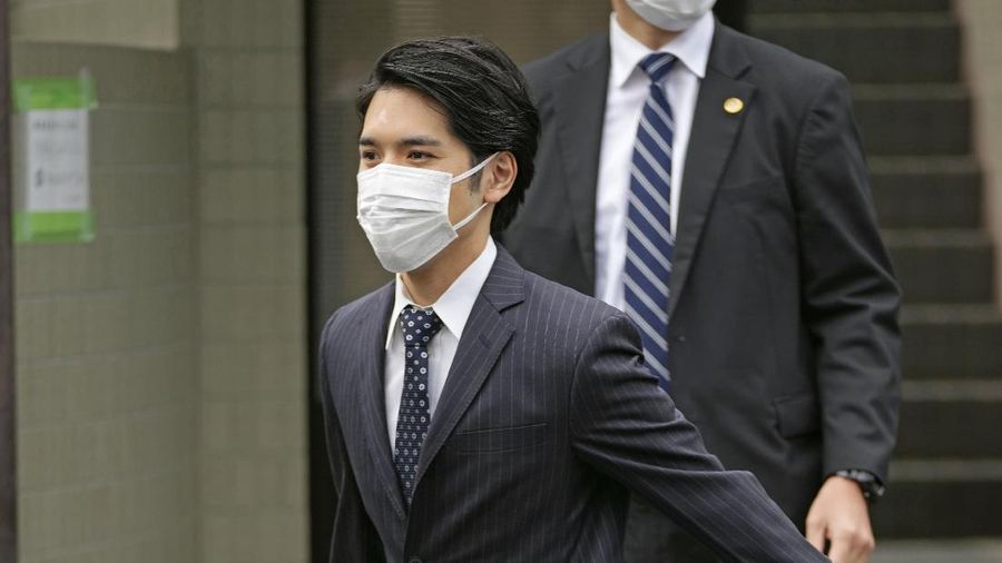 Japan's Princess Mako, right, hugs her sister Princess Kako, watched by her parents Crown Prince Akishino and Crown Princess Kiko, before leaving her home in Akasaka Estate in Tokyo Tuesday, Oct. 26, 2021. Mako and her commoner boyfriend Kei Komuro tied the knot Tuesday without wedding celebration in a marriage that has split the public opinion over her would-be mother-in-law’s financial controversy.  (Koki Sengoku/Kyodo News via AP)