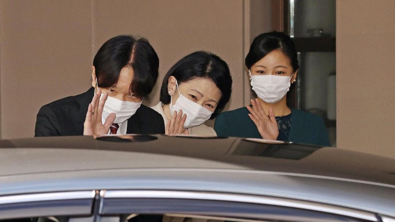 Japan's Princess Mako, right, hugs her sister Princess Kako, watched by her parents Crown Prince Akishino and Crown Princess Kiko, before leaving her home in Akasaka Estate in Tokyo Tuesday, Oct. 26, 2021. Mako and her commoner boyfriend Kei Komuro tied the knot Tuesday without wedding celebration in a marriage that has split the public opinion over her would-be mother-in-law’s financial controversy.  (Koki Sengoku/Kyodo News via AP)