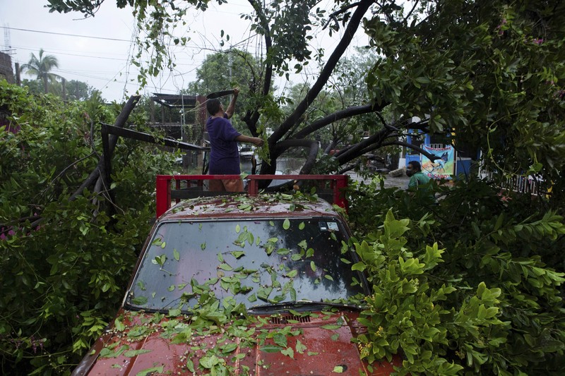 Mexico Tropical Weather A car is stuck in a flooded street due to Hurricane Rick in Lazaro Cardenas, Mexico, Monday, Oct. 25, 2021. Hurricane Rick roared ashore along Mexico's southern Pacific coast early Monday with winds and heavy rain amid warnings of potential flash floods in the coastal mountains. (AP Photo/Armando Solis)