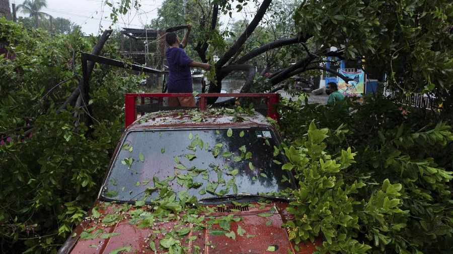 A car is stuck in a flooded street due to Hurricane Rick in Lazaro Cardenas, Mexico, Monday, Oct. 25, 2021. Hurricane Rick roared ashore along Mexico's southern Pacific coast early Monday with winds and heavy rain amid warnings of potential flash floods in the coastal mountains. (AP Photo/Armando Solis)