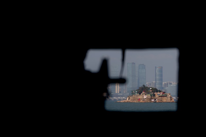 A mannequin of a soldier points a model gun from inside a bunker past Shihyu Islet, towards Xiamen, a coastal city in China, in Lieyu Township, Kinmen, Taiwan, October 19, 2021. Sitting on the front line between Taiwan and China, Kinmen is the last place where the two engaged in major fighting, in 1958 at the height of the Cold War, and where memories of war are burned into minds decades later.  REUTERS/Ann Wang    SEARCH 