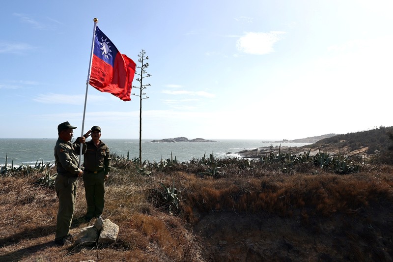 A mannequin of a soldier points a model gun from inside a bunker past Shihyu Islet, towards Xiamen, a coastal city in China, in Lieyu Township, Kinmen, Taiwan, October 19, 2021. Sitting on the front line between Taiwan and China, Kinmen is the last place where the two engaged in major fighting, in 1958 at the height of the Cold War, and where memories of war are burned into minds decades later.  REUTERS/Ann Wang    SEARCH 