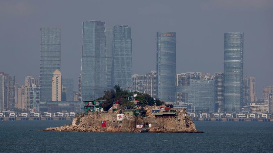 The flag of Taiwan is seen painted on Shihyu Islet in front of Xiamen, a coastal city in China, in Lieyu Township, Kinmen, Taiwan, October 19, 2021. Sitting on the front line between Taiwan and China, Kinmen is the last place where the two engaged in major fighting, in 1958 at the height of the Cold War, and where memories of war are burned into minds decades later.  REUTERS/Ann Wang    SEARCH 