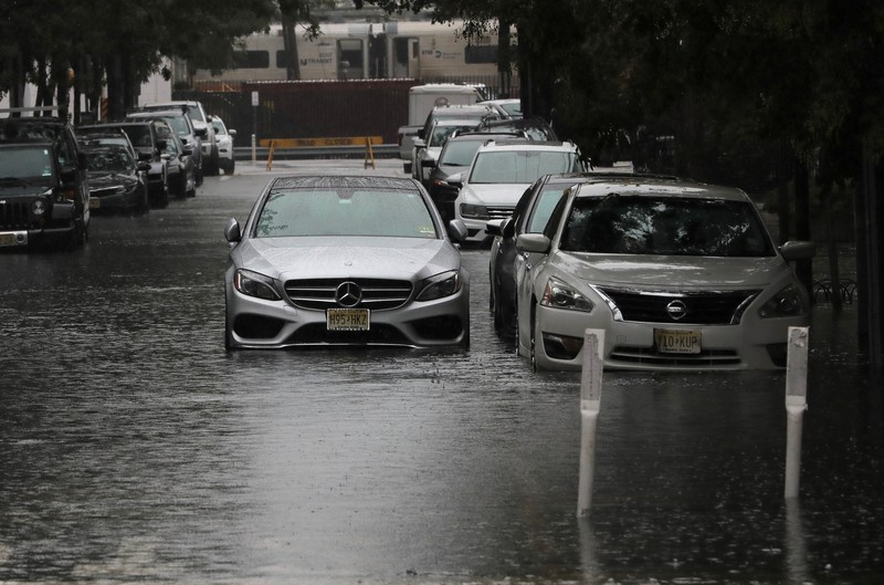 USA-WEATHER/ Flooded cars are pictured on a street as heavy rain moved into the northeast U.S. in Hoboken, New Jersey, U.S. October 26, 2021. REUTERS/Mike Segar
