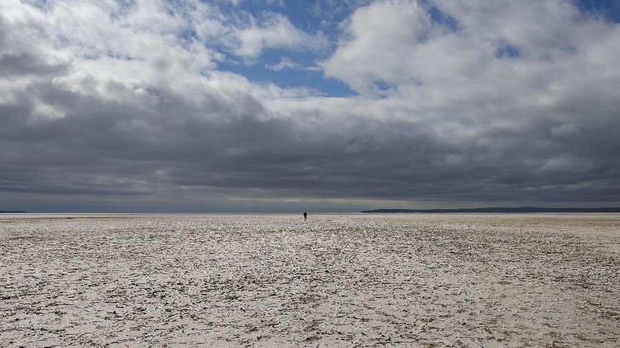 A man walks along Lake Tuz in Aksaray province, Turkey, Monday, Oct. 25, 2021. Lake Tuz, Turkey’s second largest lake, and home to several bird species has seen its waters entirely recede this year, a victim of climate change-induced drought that has hit the region as well as decades-long wrongful agricultural policies that have exhausted the lake’s underground waters. (AP Photo/Emrah Gurel)