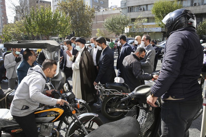 People fill their cars at a gas station in Tehran, Iran Wednesday, Oct. 27, 2021. Iran's President Ebrahim Raisi said Wednesday that a cyberattack which paralyzed every gas station in the Islamic Republic was designed to get 