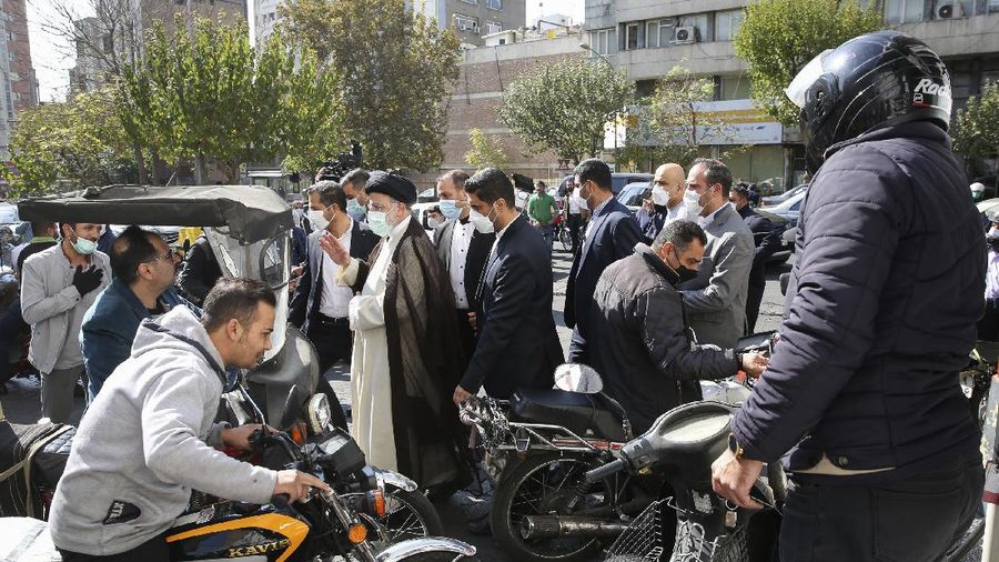 People fill their cars at a gas station in Tehran, Iran Wednesday, Oct. 27, 2021. Iran's President Ebrahim Raisi said Wednesday that a cyberattack which paralyzed every gas station in the Islamic Republic was designed to get 