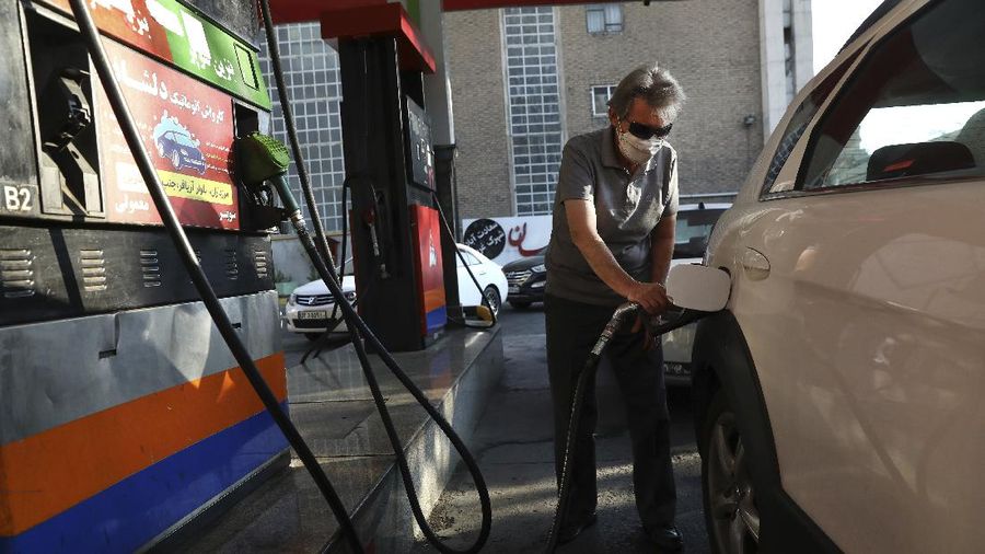 People fill their cars at a gas station in Tehran, Iran Wednesday, Oct. 27, 2021. Iran's President Ebrahim Raisi said Wednesday that a cyberattack which paralyzed every gas station in the Islamic Republic was designed to get 