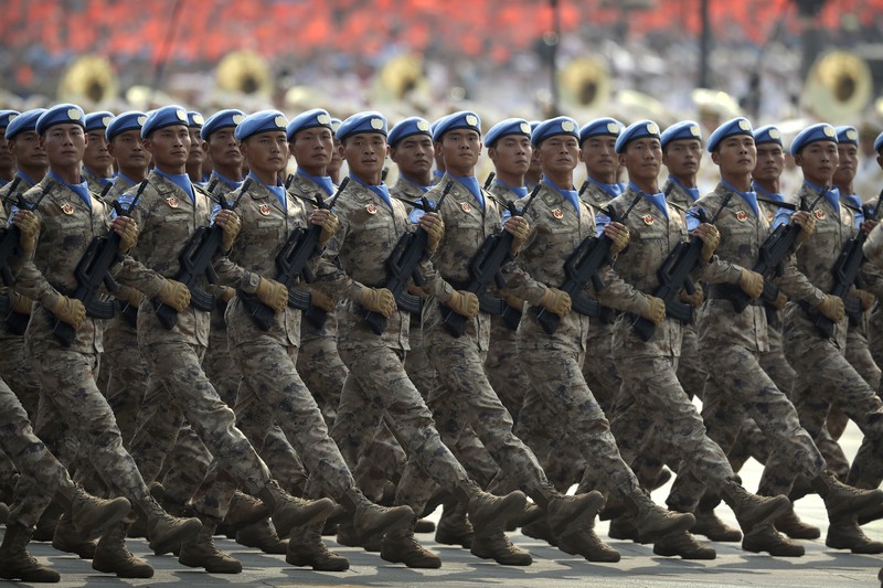 Chinese United Nations (UN) peacekeeping forces march in formation during a parade to commemorate the 70th anniversary of the founding of Communist China in Beijing, Tuesday, Oct. 1, 2019. Trucks carrying weapons including a nuclear-armed missile designed to evade U.S. defenses rumbled through Beijing as the Communist Party celebrated its 70th anniversary in power with a parade Tuesday that showcased China's ambition as a rising global force. (AP Photo/Mark Schiefelbein)