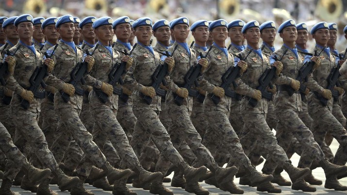 Chinese United Nations (UN) peacekeeping forces march in formation during a parade to commemorate the 70th anniversary of the founding of Communist China in Beijing, Tuesday, Oct. 1, 2019. Trucks carrying weapons including a nuclear-armed missile designed to evade U.S. defenses rumbled through Beijing as the Communist Party celebrated its 70th anniversary in power with a parade Tuesday that showcased China's ambition as a rising global force. (AP Photo/Mark Schiefelbein)