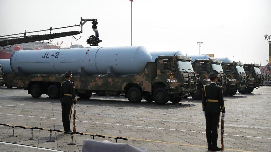 Chinese military vehicles carrying DF-17 ballistic missiles roll during a parade to commemorate the 70th anniversary of the founding of Communist China in Beijing, Tuesday, Oct. 1, 2019. Trucks carrying weapons including a nuclear-armed missile designed to evade U.S. defenses rumbled through Beijing as the Communist Party celebrated its 70th anniversary in power with a parade Tuesday that showcased China's ambition as a rising global force. (AP Photo/Mark Schiefelbein)