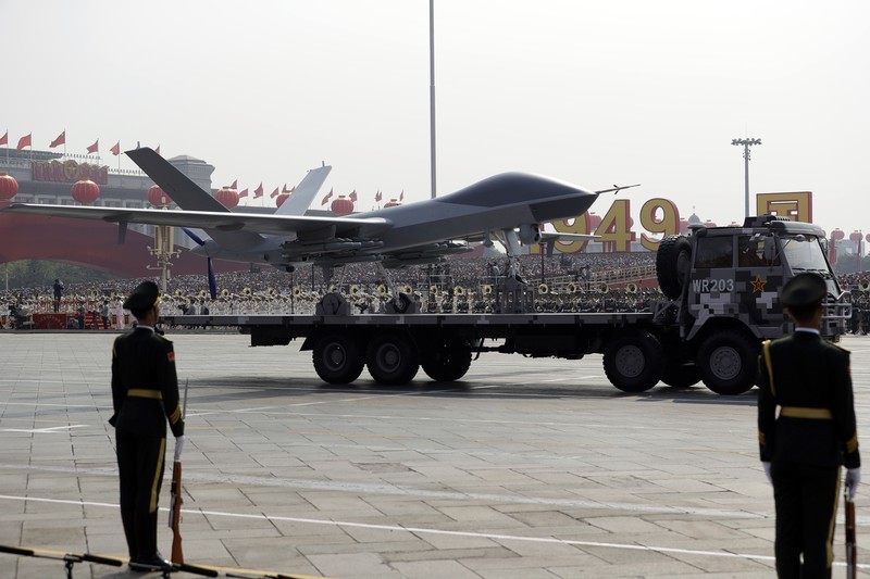 Chinese United Nations (UN) peacekeeping forces march in formation during a parade to commemorate the 70th anniversary of the founding of Communist China in Beijing, Tuesday, Oct. 1, 2019. Trucks carrying weapons including a nuclear-armed missile designed to evade U.S. defenses rumbled through Beijing as the Communist Party celebrated its 70th anniversary in power with a parade Tuesday that showcased China's ambition as a rising global force. (AP Photo/Mark Schiefelbein)