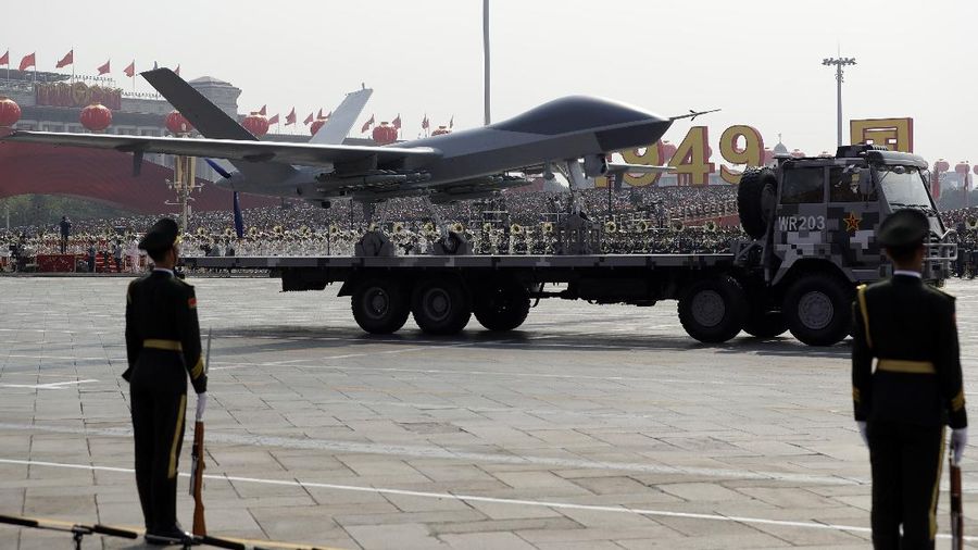 Chinese United Nations (UN) peacekeeping forces march in formation during a parade to commemorate the 70th anniversary of the founding of Communist China in Beijing, Tuesday, Oct. 1, 2019. Trucks carrying weapons including a nuclear-armed missile designed to evade U.S. defenses rumbled through Beijing as the Communist Party celebrated its 70th anniversary in power with a parade Tuesday that showcased China's ambition as a rising global force. (AP Photo/Mark Schiefelbein)