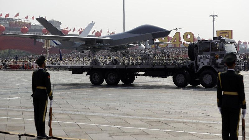 Chinese United Nations (UN) peacekeeping forces march in formation during a parade to commemorate the 70th anniversary of the founding of Communist China in Beijing, Tuesday, Oct. 1, 2019. Trucks carrying weapons including a nuclear-armed missile designed to evade U.S. defenses rumbled through Beijing as the Communist Party celebrated its 70th anniversary in power with a parade Tuesday that showcased China's ambition as a rising global force. (AP Photo/Mark Schiefelbein)