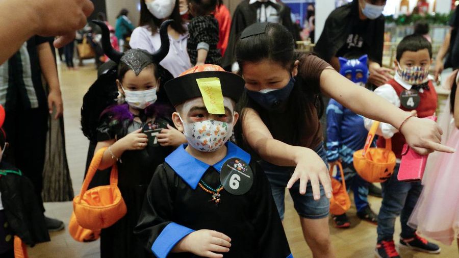 A participant wearing a costume walks on the bridge during a parade and costume competition ahead of Halloween at a shopping mall in Jakarta, Indonesia, October 30, 2021. REUTERS/Ajeng Dinar Ulfiana
