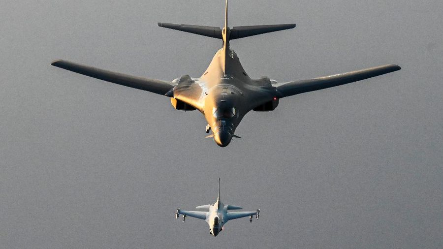 In this photo released by the U.S. Air Force, F-16s flown by the Egyptian Air Force break away from a U.S. Air Force B-1B Lancer over Egypt Saturday, Oct. 30, 2021. The U.S. Air Force said Sunday it flew a B-1B strategic bomber over key maritime chokepoints in the Mideast with allies including Israel amid ongoing tensions with Iran as its nuclear deal with world powers remains in tatters. (U.S. Air Force/Senior Airman Jerreht Harris via AP)