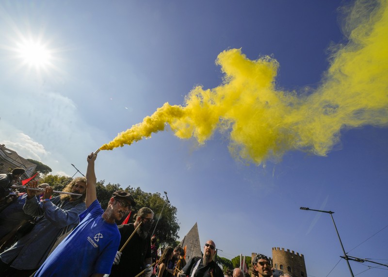 Italian Police remove climate activists trying to block traffic in front of the Italian Ministry of the Ecological Transition in Rome's via Cristoforo Colombo, one of the main road leading to La Nuvola (the cloud) convention center where the G20 summit is taking place, Saturday, Oct. 30, 2021. (AP Photo/Luca Bruno)