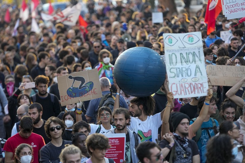 Italian Police remove climate activists trying to block traffic in front of the Italian Ministry of the Ecological Transition in Rome's via Cristoforo Colombo, one of the main road leading to La Nuvola (the cloud) convention center where the G20 summit is taking place, Saturday, Oct. 30, 2021. (AP Photo/Luca Bruno)