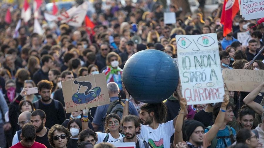 Italian Police remove climate activists trying to block traffic in front of the Italian Ministry of the Ecological Transition in Rome's via Cristoforo Colombo, one of the main road leading to La Nuvola (the cloud) convention center where the G20 summit is taking place, Saturday, Oct. 30, 2021. (AP Photo/Luca Bruno)