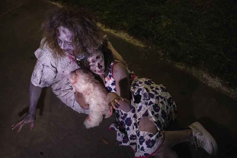 People wearing costumes wait in the rain to enter the Official Salem Witches' Halloween Ball in Salem, Massachusetts, U.S., October 30, 2021.   REUTERS/Reba Saldanha     TPX IMAGES OF THE DAY