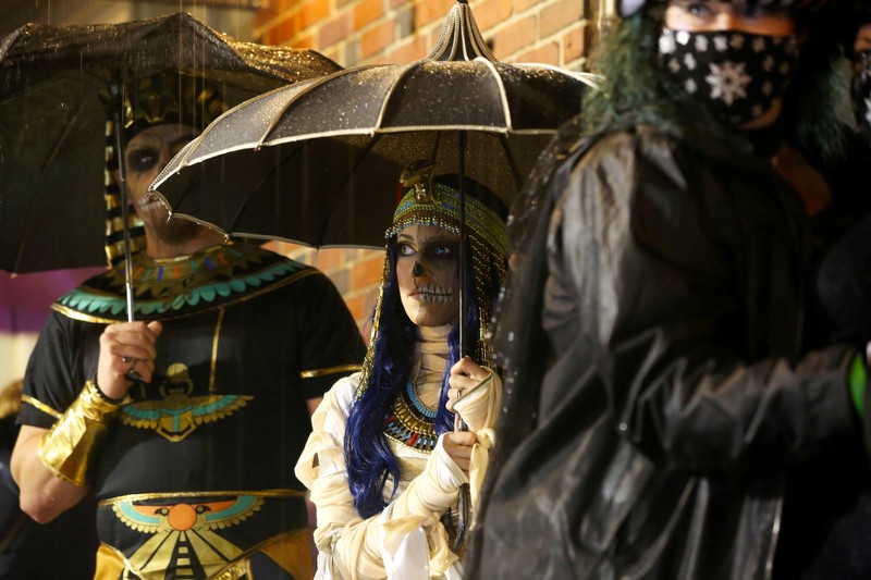 People wearing costumes wait in the rain to enter the Official Salem Witches' Halloween Ball in Salem, Massachusetts, U.S., October 30, 2021.   REUTERS/Reba Saldanha     TPX IMAGES OF THE DAY