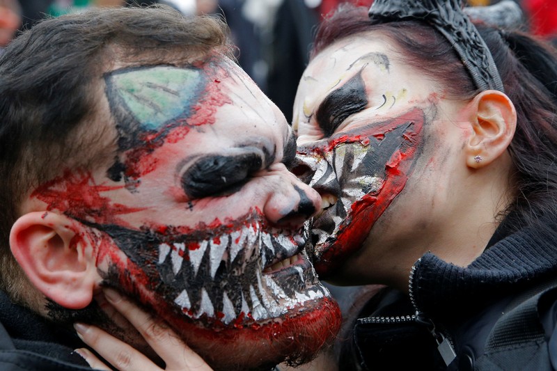 People wearing costumes wait in the rain to enter the Official Salem Witches' Halloween Ball in Salem, Massachusetts, U.S., October 30, 2021.   REUTERS/Reba Saldanha     TPX IMAGES OF THE DAY