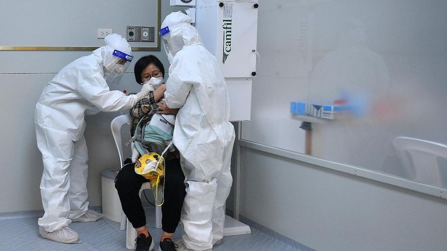 Health workers wearing protective suits administer the COVID-19 swab test on a tourist after they arrive a hotel during the first day of the country's reopening campaign, part of the government's plan to jump start the pandemic-hit tourism sector in Bangkok, Thailand November 1, 2021. REUTERS/Chalinee Thirasupa